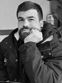 Portrait of young man standing at home