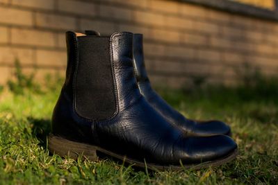 Close-up of black shoes on wall