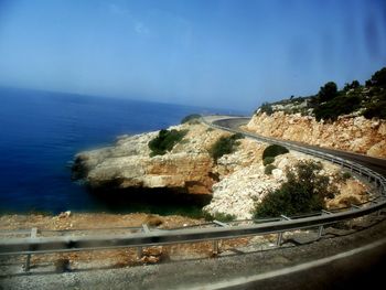 View of coastline against blue sky