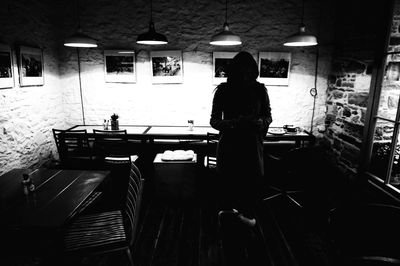 Woman standing in illuminated room