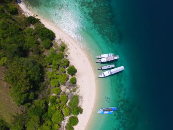 High angle view boats on beach in bidadari island flores