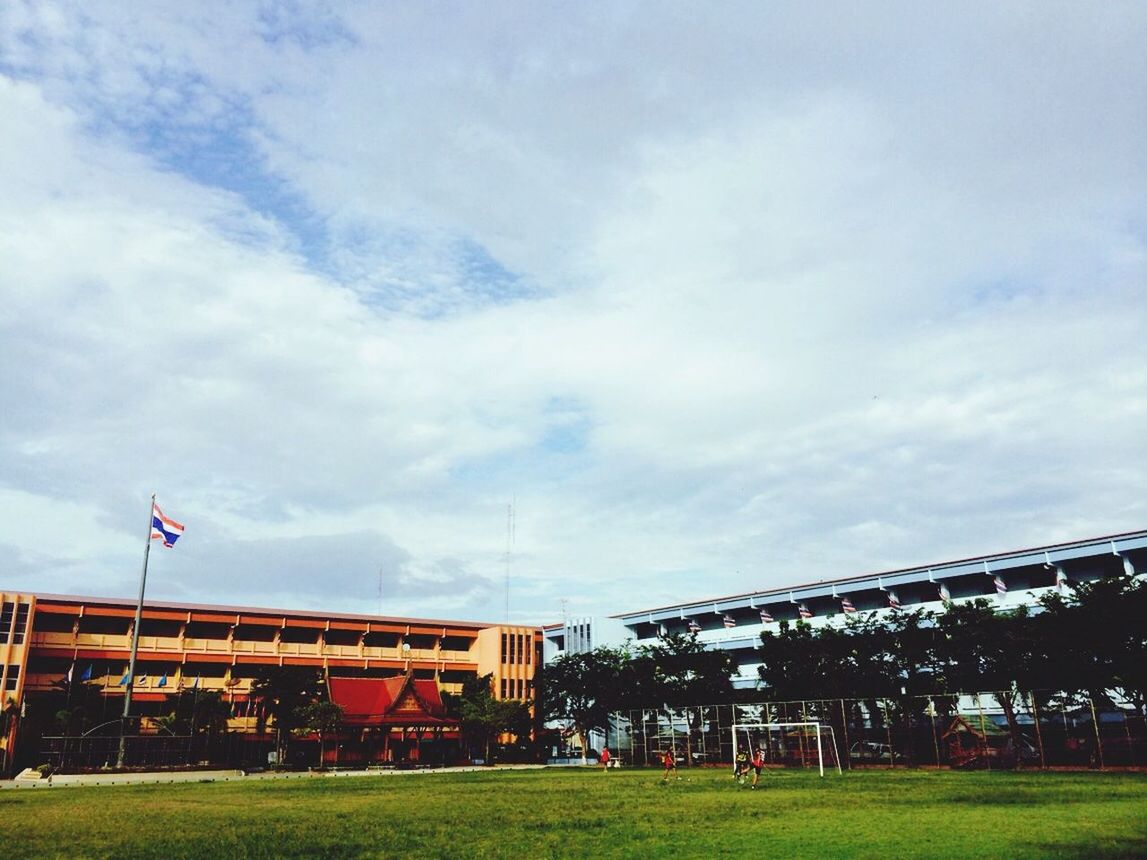 sky, building exterior, architecture, built structure, grass, cloud - sky, cloudy, field, transportation, cloud, day, green color, outdoors, mode of transport, grassy, no people, land vehicle, nature, city, incidental people