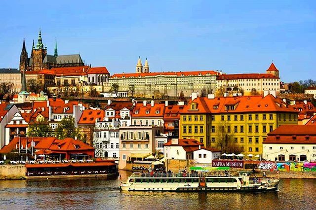 VIEW OF RIVER WITH BUILDINGS IN BACKGROUND