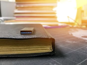 Close-up of book on table against fire