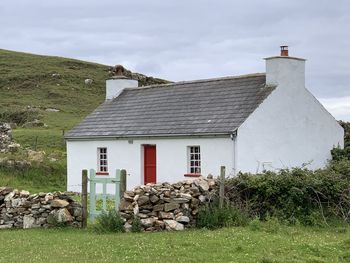 House on field against sky