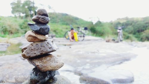 Stack of statue on rock against sky
