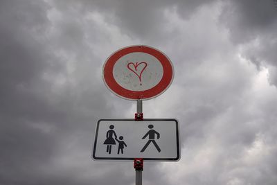 Low angle view of road sign against sky