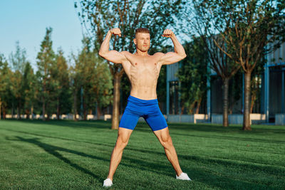 Full length of man exercising on field