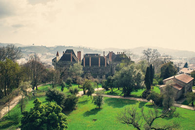 Panoramic view of trees and houses against sky