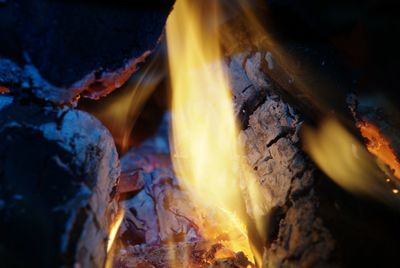 Detail view into fireplace ember wood. glowing embers in hot red color.