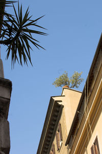 Low angle view of built structure against clear blue sky