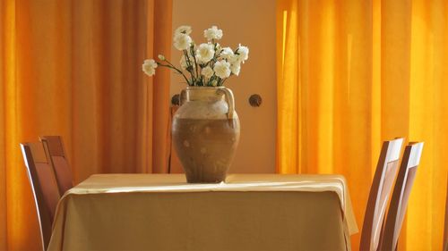 Close-up of flower vase on table at home