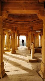 Rear view of man standing in historic building