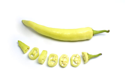 Close-up of green chili pepper against white background