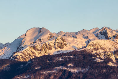 Scenic view of snowcapped mountains against clear sky