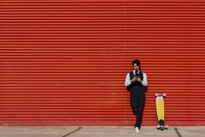 Full length of a woman walking with umbrella