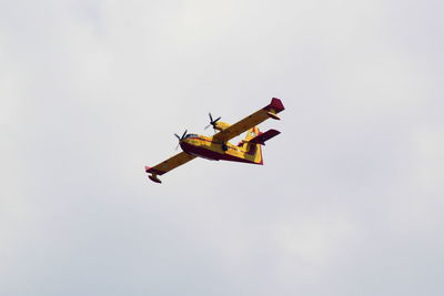 Low angle view of airplane against sky