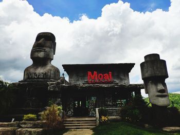 Low angle view of statue against temple against sky