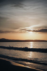 Scenic view of beach against sky during sunset