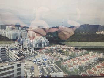 Aerial view of cityscape against sky