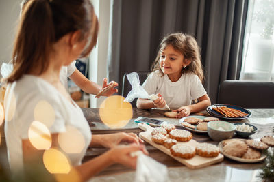 Happy girl having food on table