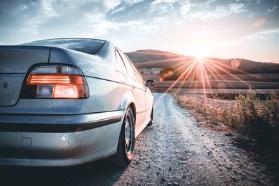 Car on road against sky during sunset