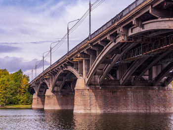 Low angle view of bridge over river against sky