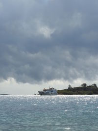 Ship sailing on sea against sky