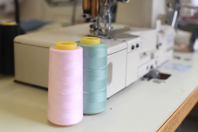 Close-up of spool by sewing machine at workshop