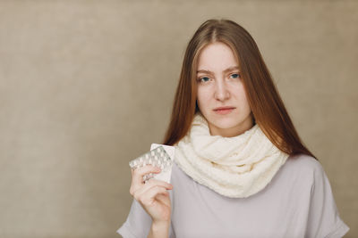 Portrait of young woman holding gift