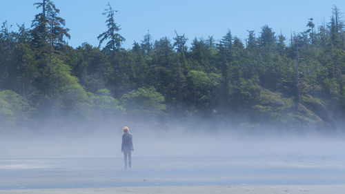 Full length of man standing on land against trees