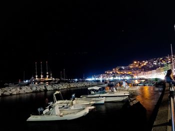 Boats in harbor at night