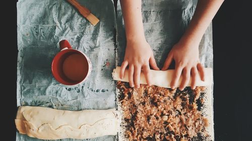 Midsection of woman holding coffee cup on table