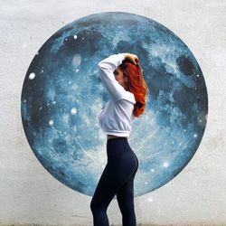 Full length of young woman standing against white background