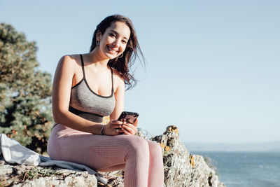 Young woman sitting at beach