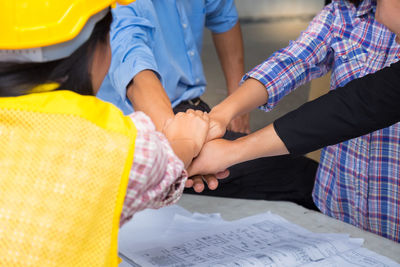 Low section of people standing on paper