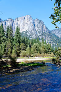 Scenic view of mountains against blue sky