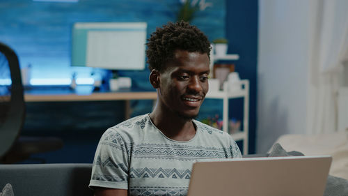 Young man using laptop at home