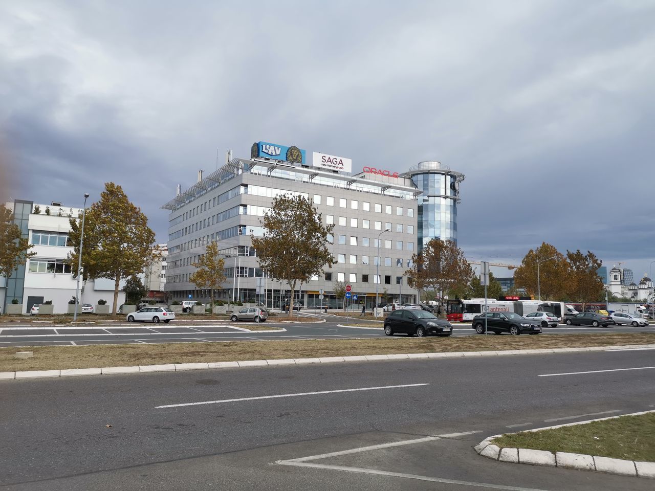 VIEW OF CITY STREET AGAINST CLOUDY SKY