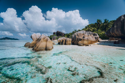 Panoramic view of rocks on beach against sky