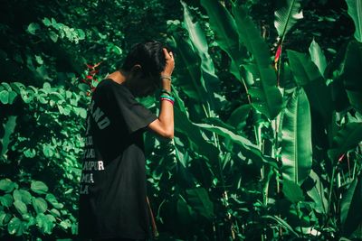 Full length of man standing amidst plants