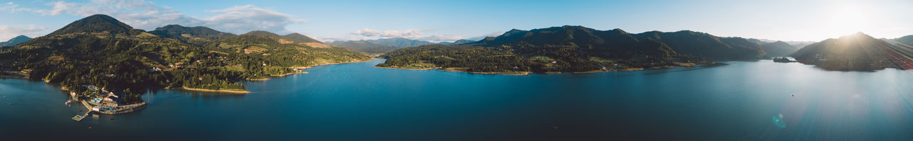 Panoramic view of sea and mountains against sky