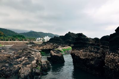 Panoramic view of river and rocks against sky