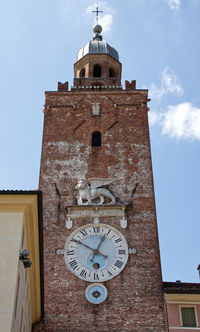 Low angle view of clock tower against sky