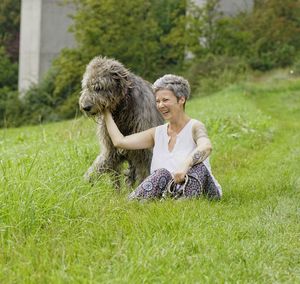 View of woman with dog on grass