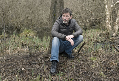 Portrait of man sitting in grass