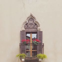 Low angle view of cross on building wall