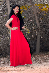 Portrait of young woman standing on land