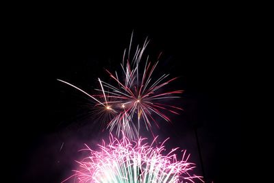 Low angle view of firework display at night