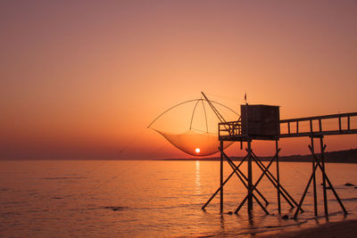 Scenic view of sea against orange sky